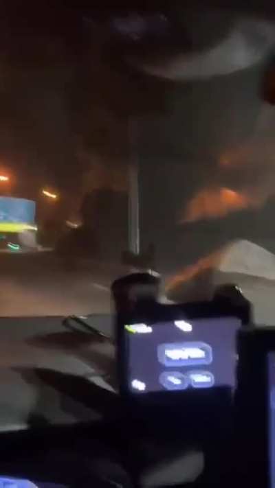 An Iranian ballistic missile narrowly misses a motorist on an Israeli highway