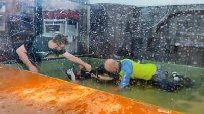 Crocodile attacks zoo keeper and a visitor jumps in the cage to help