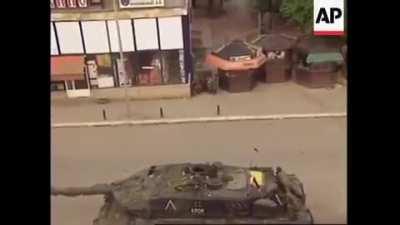 2 Serbian paramilitary open fire on a KFOR checkpoint from inside a car hitting a german soldier in the arm. Infantry and dismounted crew of the stationed vehicles, including a Leopard 2a5 and a Fuchs APC, return fire killing the driver and mortally wound