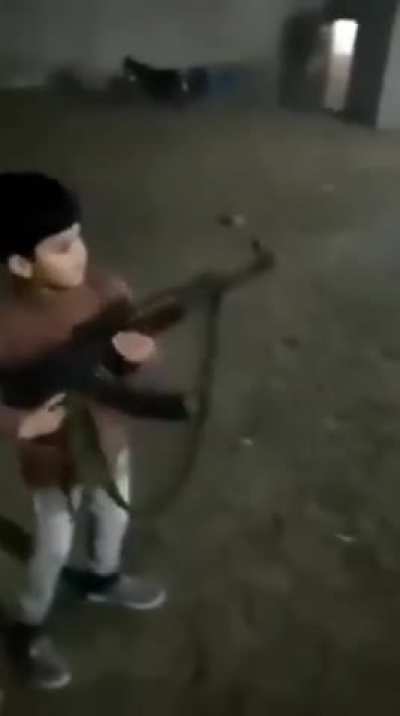 Syrian child shooting a ak47 then killed by a sniper