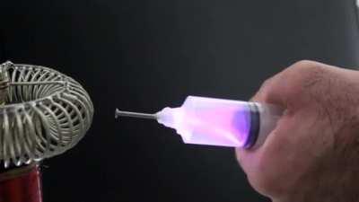 Extracting electricity from a tesla coil using a syringe. OP: u/solateor