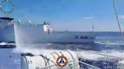 A Philippine Coast Guard Parola-class MRRV steers clear of the larger China Coast Guard vessels, as it fires off it's high powered water-cannons. During the interdiction of a resupply run to one of the Philippine outposts.