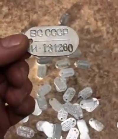 Ukrainian forces with a collection of dog tags from deceased Russian military