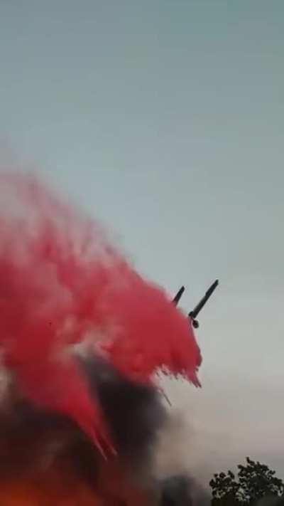 DC-10-30 VLAT slurry drop on a wildfire engulfing a neighborhood