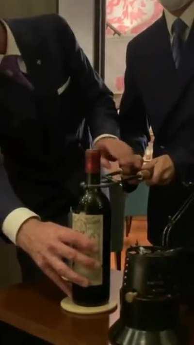 Opening a $15,000 bottle of Petrus, 1961 with heated tools. This method is used to make sure that the cork stays intact.