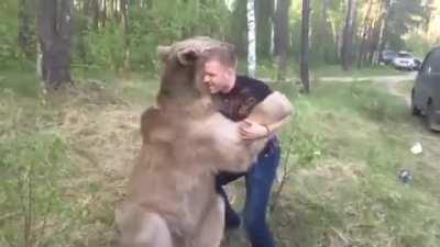 Russian guy plays with bear