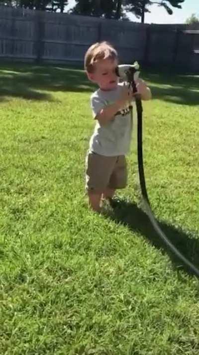 funny baby playing with water