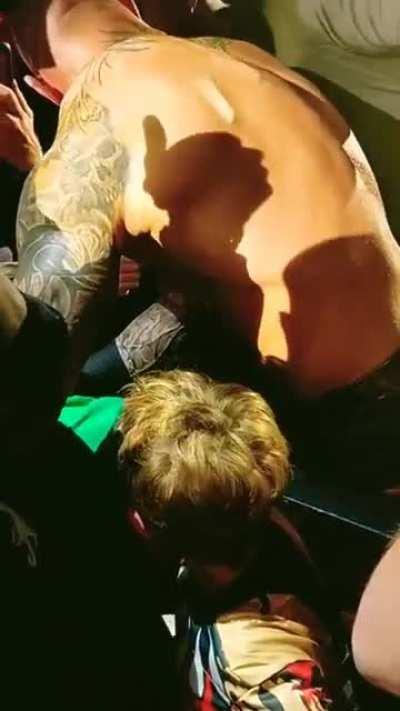 Randy Orton saves the kid from getting crushed between the spectators