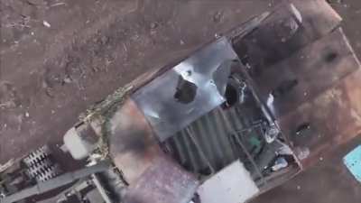 A Ukrainian drone operator drops an M67 grenade through the open hatch of a Russian T-72B3 &quot;Turtle&quot; MBT equipped with a mine roller. 