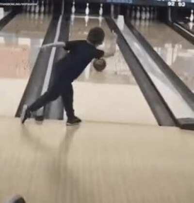 Kid finishes off a round with an amazing split at the bowling alley