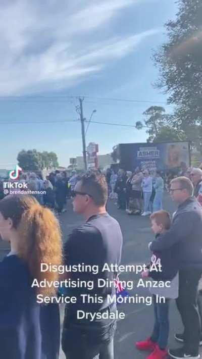 A mobile billboard advertising for federal Liberal candidate Stephanie Asher drives directly pass a crowd during at least one Anzac Day service in Geelong.