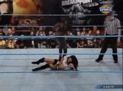 Naomi dragging and kicking AJ around