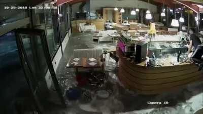 Wave crashes through restaurant windows in Italy