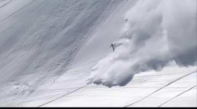 Skier outrunning an avalanche does a backflip