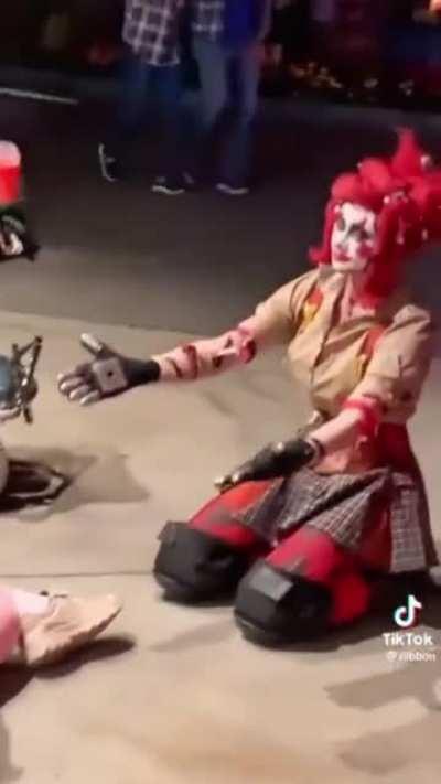 This clown making someone tie their shoes