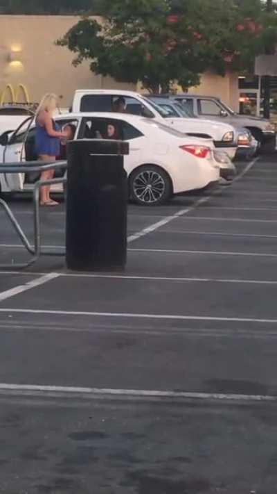 Girl pees in cup and pours it on car in parking lot