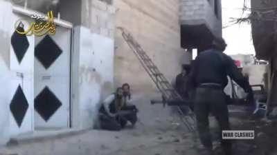 Syrian rebel wields a shoulder mounted DShK machine gun in Daraya