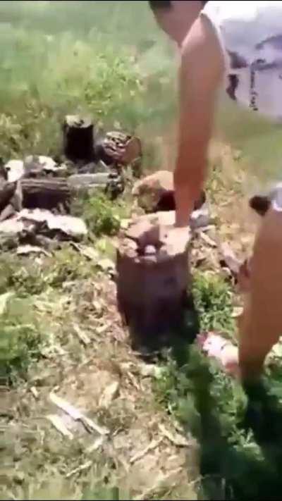 Woman decapitates a kitten with an axe while her friend films and laughs