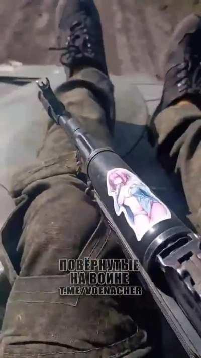 Russian Soldier going to war with an interesting attachment to his AK