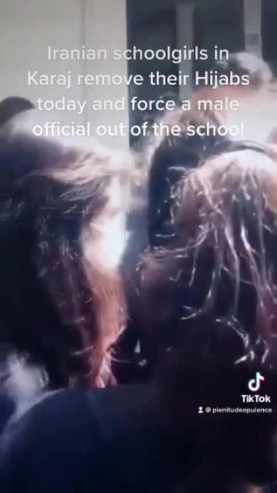 Iranian schoolgirls in Karaj remove their Hijabs today and force a male official out of the school