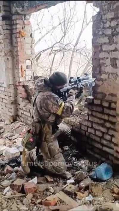 Ukrainian soldier firing his marksman rifle at Russian troops