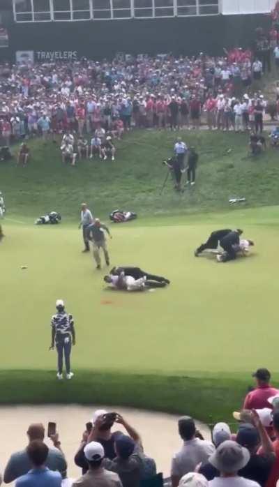 Crowd boos protestors as they’re swarmed by police at golf tournament