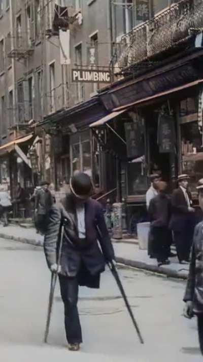 1991 NEW YORK CITY, UNITED STATES AMPUTEE WALKS THROUGH CHINA TOWN. (RESTORED VIDEO)