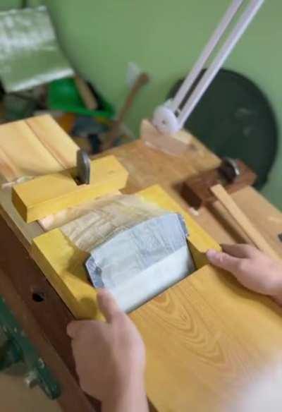 Cutting very thin slices of wood.