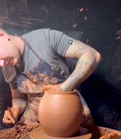 A potter effortlessly crafts a piece of art