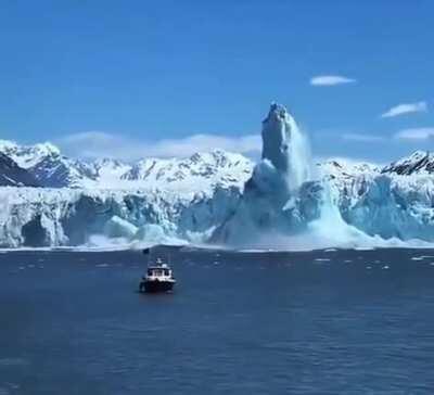 An iceberg rising and forming a huge pillar after falling