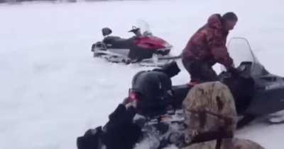 WCGW Standing behind Snow mobile