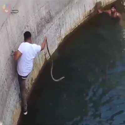 We are actually very badass. A group of people saving an Indian cobra from drowning in well.