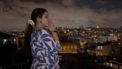 Balcony Bliss Girl in Blue Dress Smoking