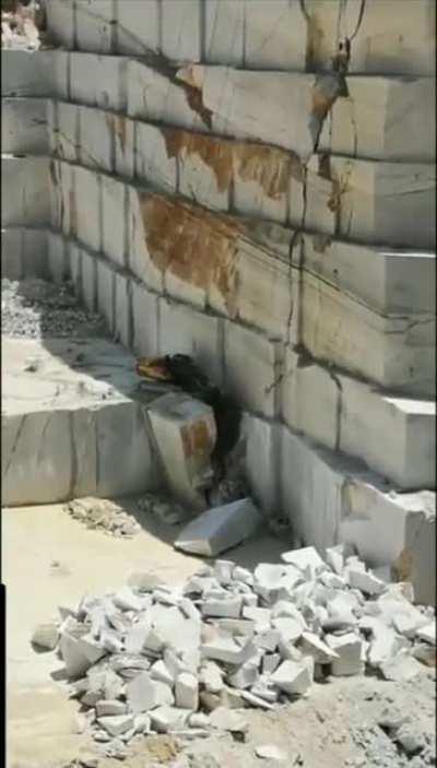 The size of this marble quarry makes the excavator working on it look like a toy.