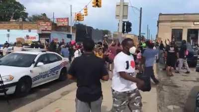 People protesting in Detroit because the police shot a black man who tried to kill a cop