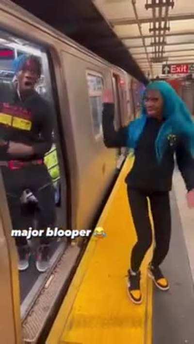 Two POS's holding up the subway to do a TikTok dance.