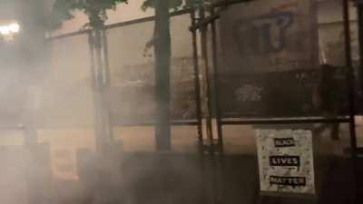 The Portland Imperial March: Federal Officers fire impact munitions through the fence (Twitter source: @MrOlmos)