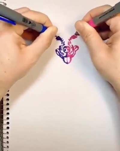 Drawing with both hands making one picture