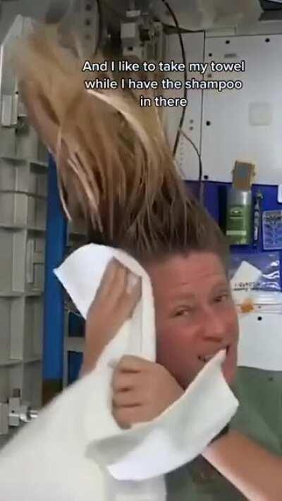 Karen Nyberg demonstrating how to wash long hair in space.