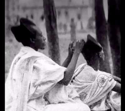 100 year old photo, showing a man wearing Amasunzu, a traditional hairstyle in west Africa..