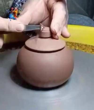 Making a pottery jar.