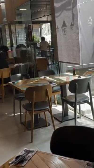 a woman dancing in a middle of a restaurant