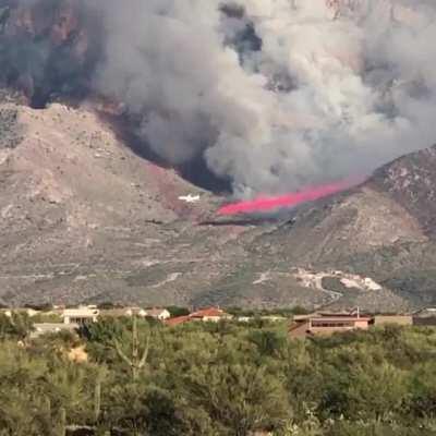 An airplane dumping fire retardant on the Pusch ridge fire yesterday.