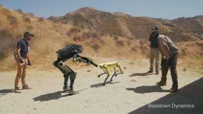 Humans bully a robot to kill a robotic dog