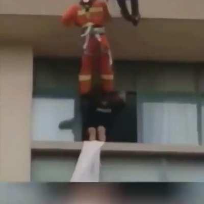 These firemen kicking people to prevent them from ending their own lives.