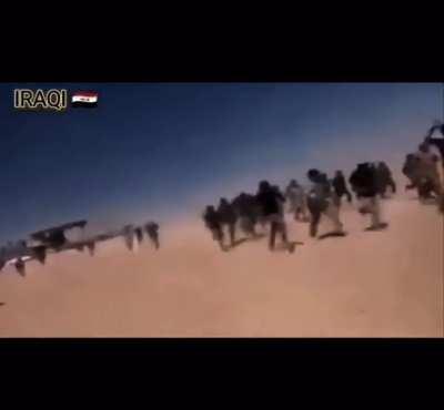 Dozens of Iraqi pmf militants charging an open field towards IS position following the retreat of IS militants, periphery of Baiji,2015.