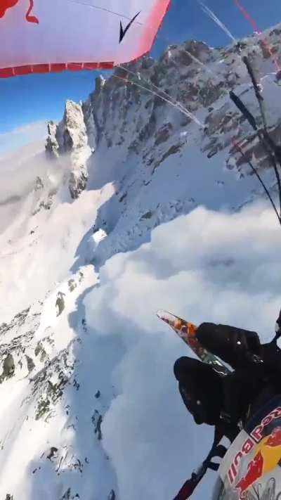 Skier avoids avalanche by paragliding over it