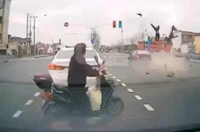 Elderly couple crossing incorrectly on moped didn't see speeding car in the near lane.