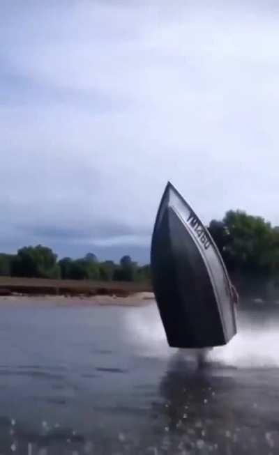 Man performs motorcycle moves with a boat 