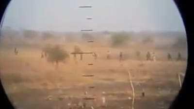 South Sudan Rebels launch a massive assault an SPLA (Sudan People's Liberation Army) position near Malakal Refugee Camp. Filmed by an Indian U.N. Peacekeeper with a smartphone through a binocular lens [2014]